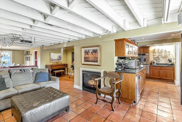 tiled living room featuring beam ceiling