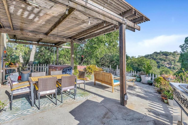 view of patio / terrace with a hot tub