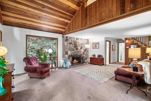 living room featuring light carpet, wood ceiling, a stone fireplace, and lofted ceiling