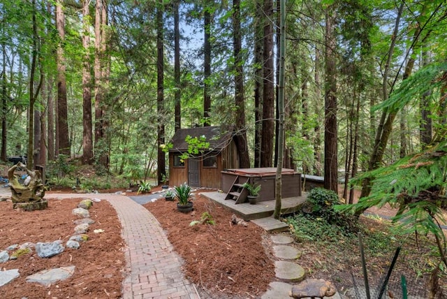 view of yard with an outbuilding and a hot tub