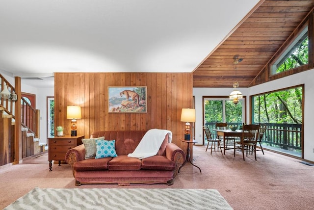 living room featuring high vaulted ceiling, wood ceiling, wood walls, and carpet floors