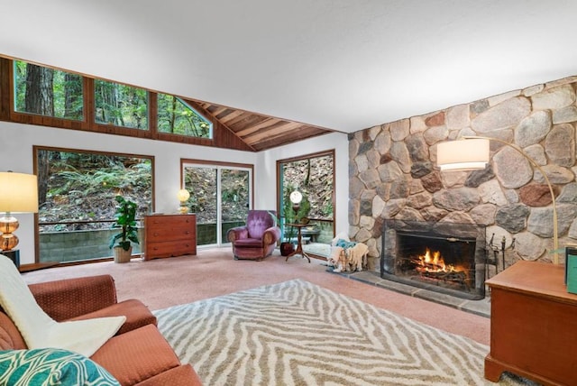 carpeted living room with vaulted ceiling, wooden ceiling, and a stone fireplace