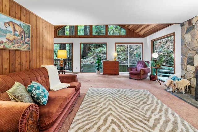 living room featuring carpet floors, a fireplace, wooden walls, vaulted ceiling, and wooden ceiling