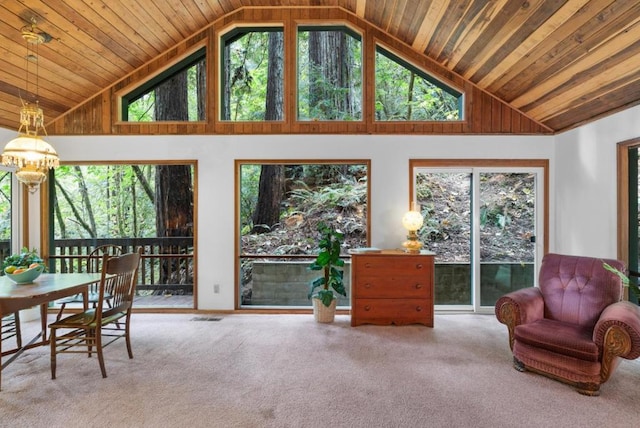 sunroom / solarium featuring lofted ceiling and a notable chandelier