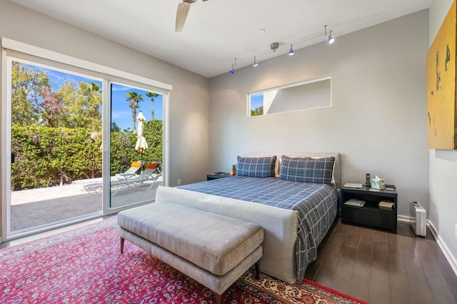 bedroom featuring access to outside, ceiling fan, and dark hardwood / wood-style floors