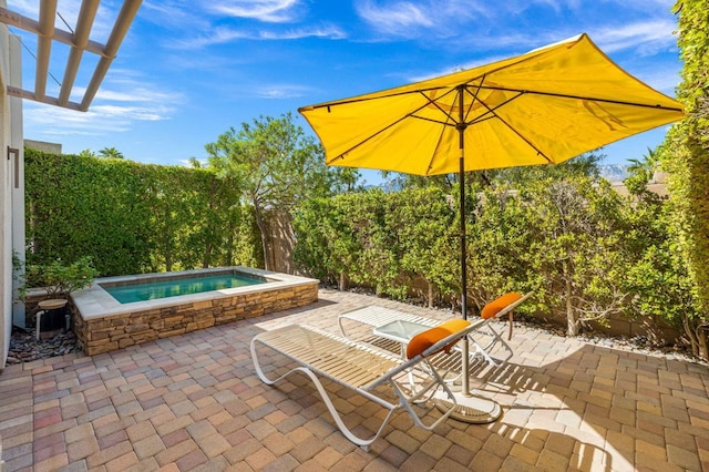 view of patio / terrace featuring an in ground hot tub