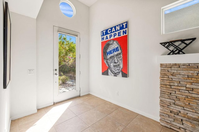 entryway with light tile patterned flooring and a wealth of natural light