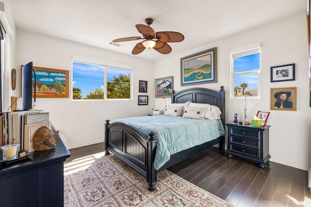 bedroom with ceiling fan and dark wood-type flooring