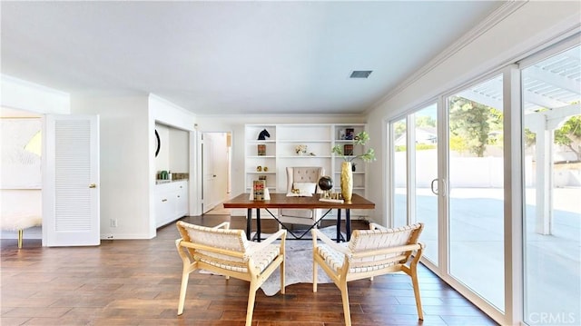 home office with ornamental molding and dark wood-type flooring