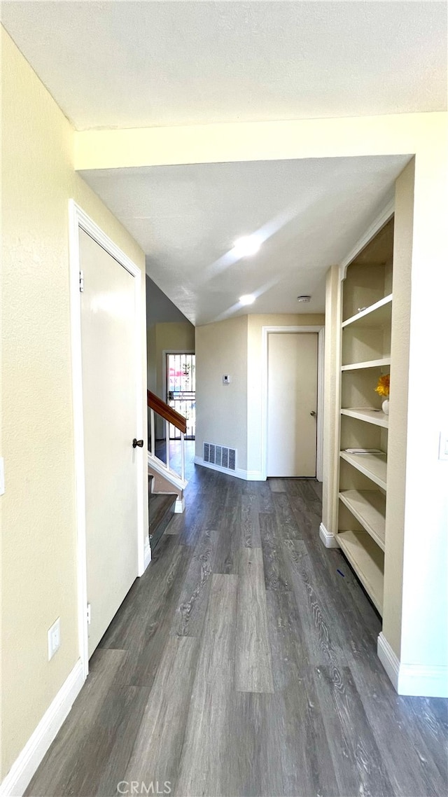 corridor featuring dark hardwood / wood-style flooring