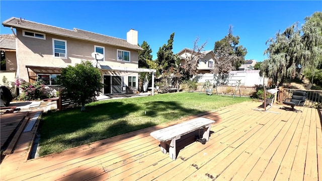 deck featuring a lawn and a pergola