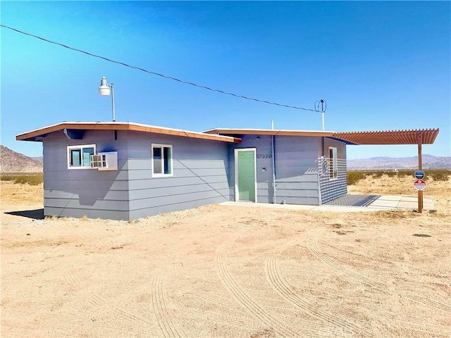 rear view of property featuring a mountain view