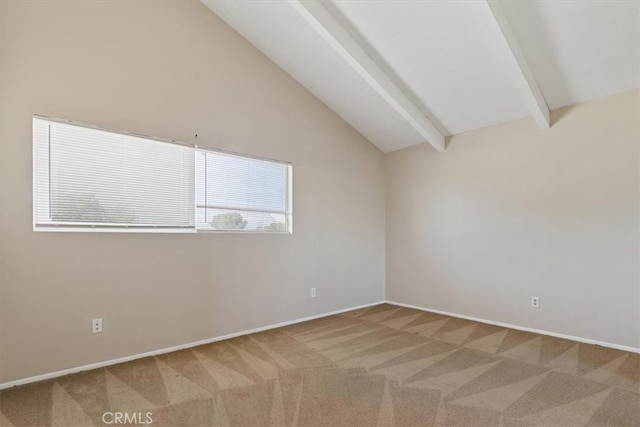 empty room with vaulted ceiling with beams and carpet flooring