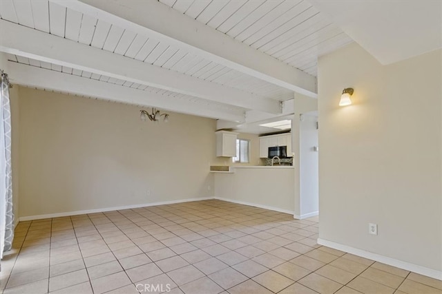 unfurnished living room with beamed ceiling, wood ceiling, and light tile patterned floors