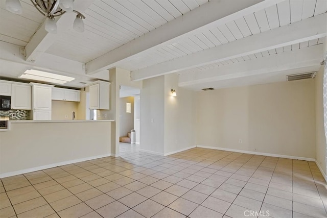 tiled empty room featuring an inviting chandelier, beamed ceiling, and wood ceiling