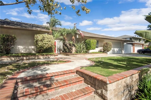 view of front of house featuring a garage and a front yard