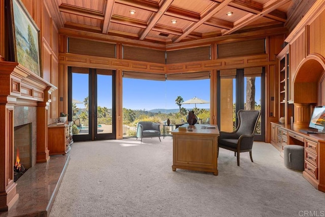 office featuring coffered ceiling, beam ceiling, a high end fireplace, wood ceiling, and wooden walls