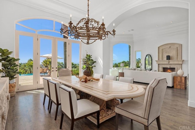 dining room with ornamental molding, a chandelier, french doors, and dark hardwood / wood-style floors