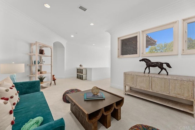 carpeted living room featuring ornamental molding