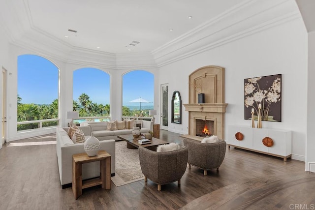 living room with plenty of natural light, dark hardwood / wood-style floors, and ornamental molding