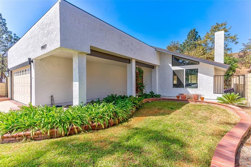 contemporary house with a garage and a front lawn