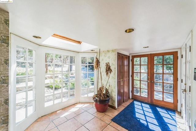 entryway with french doors, light tile patterned floors, and a healthy amount of sunlight