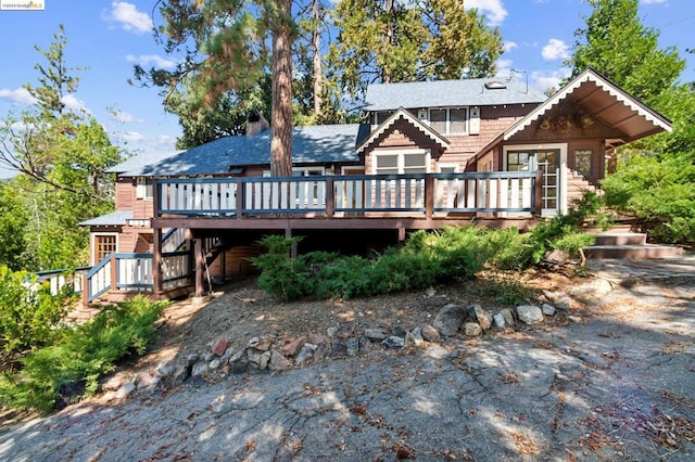 back of house featuring a deck