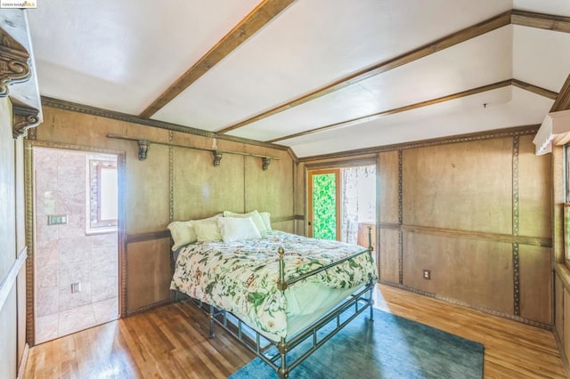 bedroom with hardwood / wood-style flooring and vaulted ceiling with beams