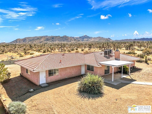 birds eye view of property with a mountain view