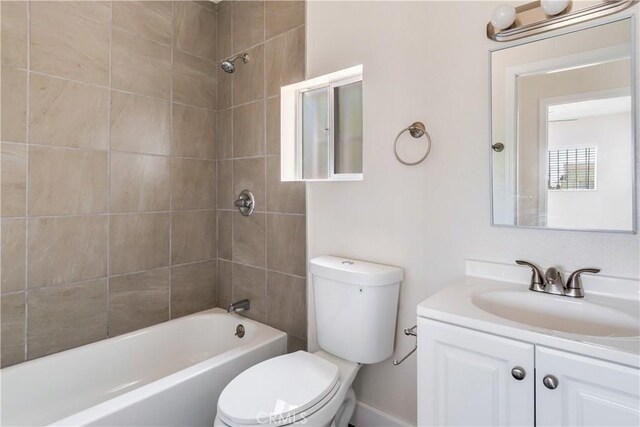 full bathroom featuring vanity, toilet, and tiled shower / bath