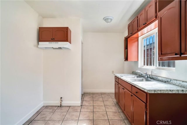 916 W 88th St, Los Angeles, CA 90044 - kitchen featuring light countertops, baseboards, light tile patterned floors, a sink, and under cabinet range hood