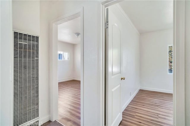 916 W 88th St, Los Angeles, CA 90044 - corridor with baseboards, wood finished floors, and a heating unit