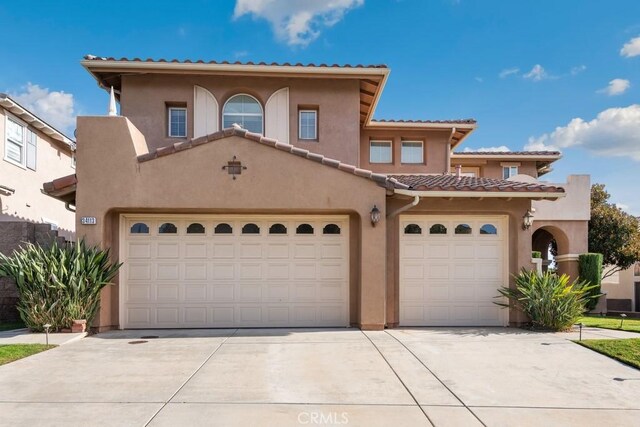 mediterranean / spanish house with a garage