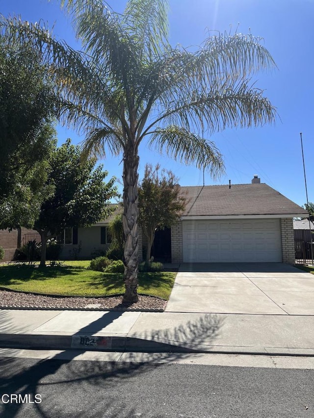 view of front facade with a front yard and a garage