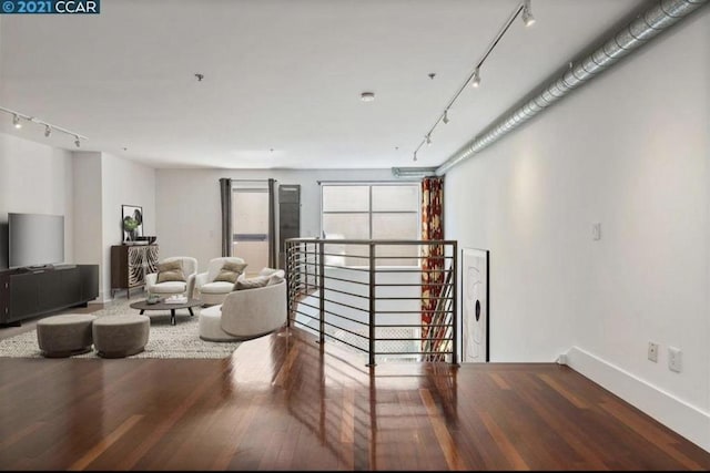 living room with hardwood / wood-style flooring and rail lighting