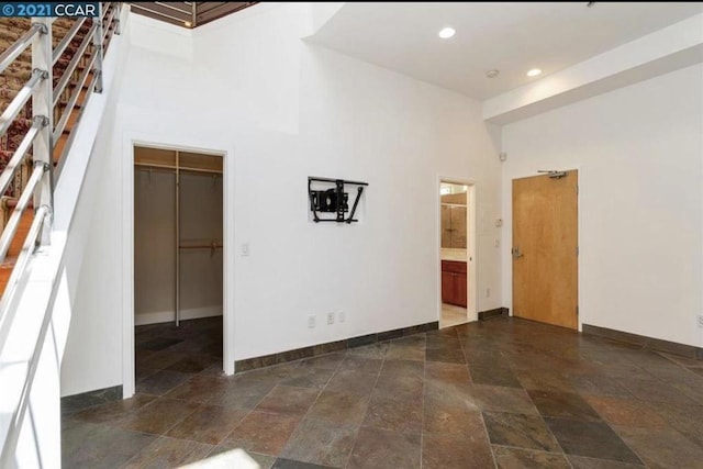 empty room featuring a towering ceiling