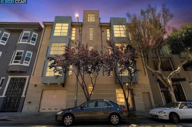 view of outdoor building at dusk