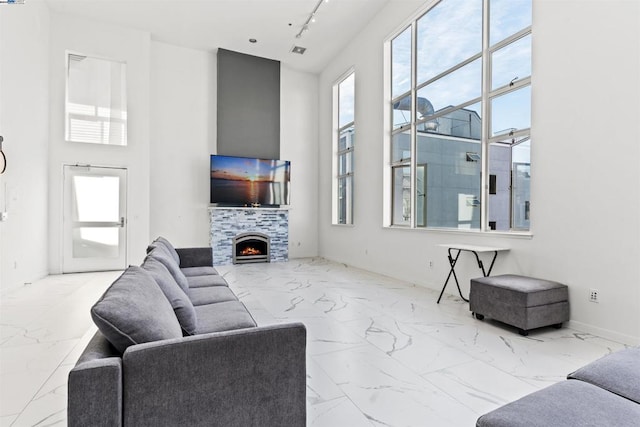 living room with a tiled fireplace and rail lighting