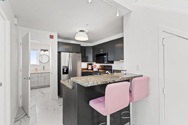 kitchen featuring kitchen peninsula, a kitchen bar, stone counters, and black appliances