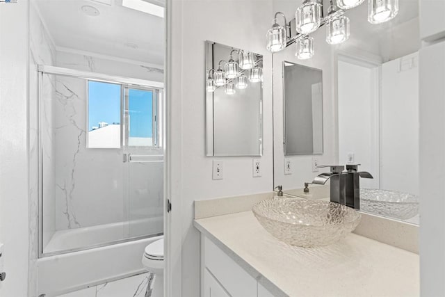 full bathroom with shower / bath combination with glass door, vanity, and toilet