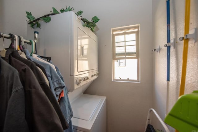 clothes washing area with stacked washer and clothes dryer