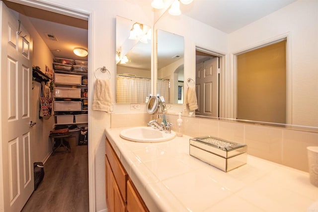 bathroom with vanity and hardwood / wood-style flooring