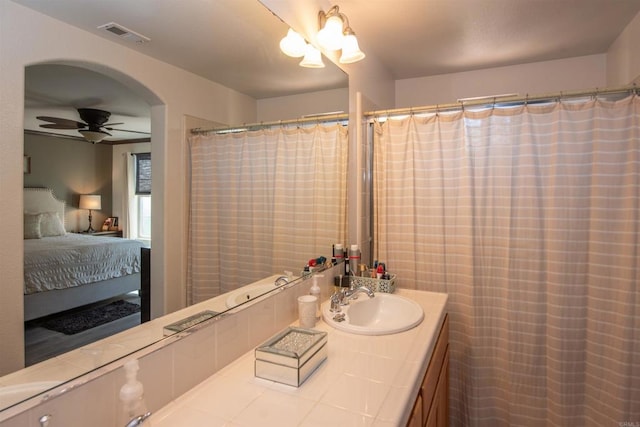 bathroom featuring a shower with curtain, vanity, and ceiling fan