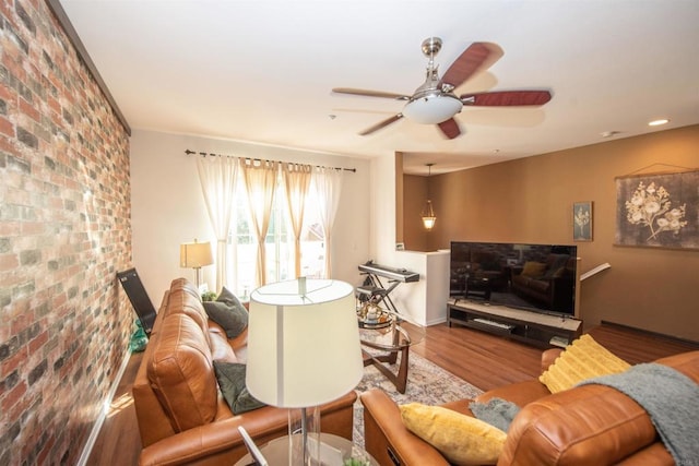 living room featuring wood-type flooring and ceiling fan