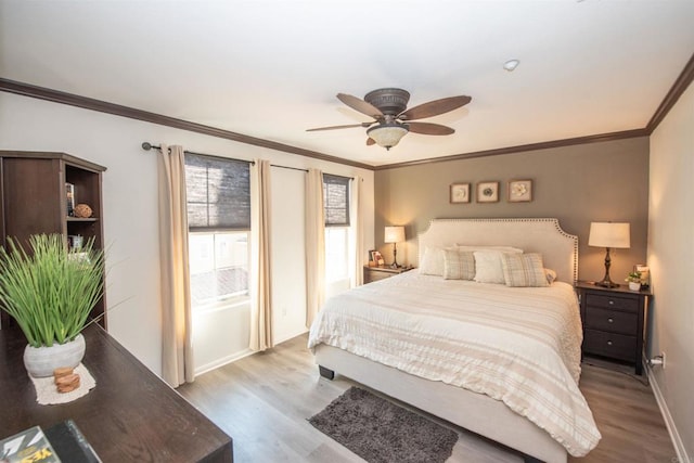 bedroom with ceiling fan, light wood-type flooring, and crown molding