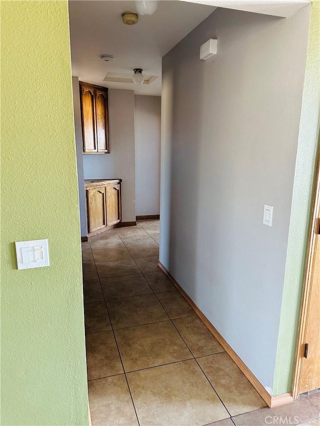 corridor with light tile patterned flooring