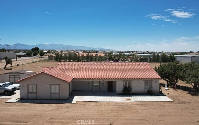 view of front of house featuring a mountain view and a patio