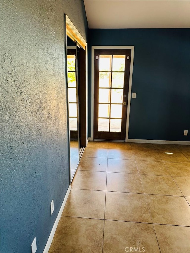 doorway featuring light tile patterned floors