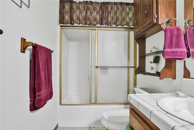 full bathroom with toilet, enclosed tub / shower combo, and vanity