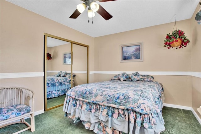 carpeted bedroom featuring ceiling fan and a closet